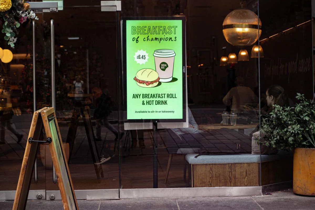 A digital breakfast promotion displayed in a cafe window